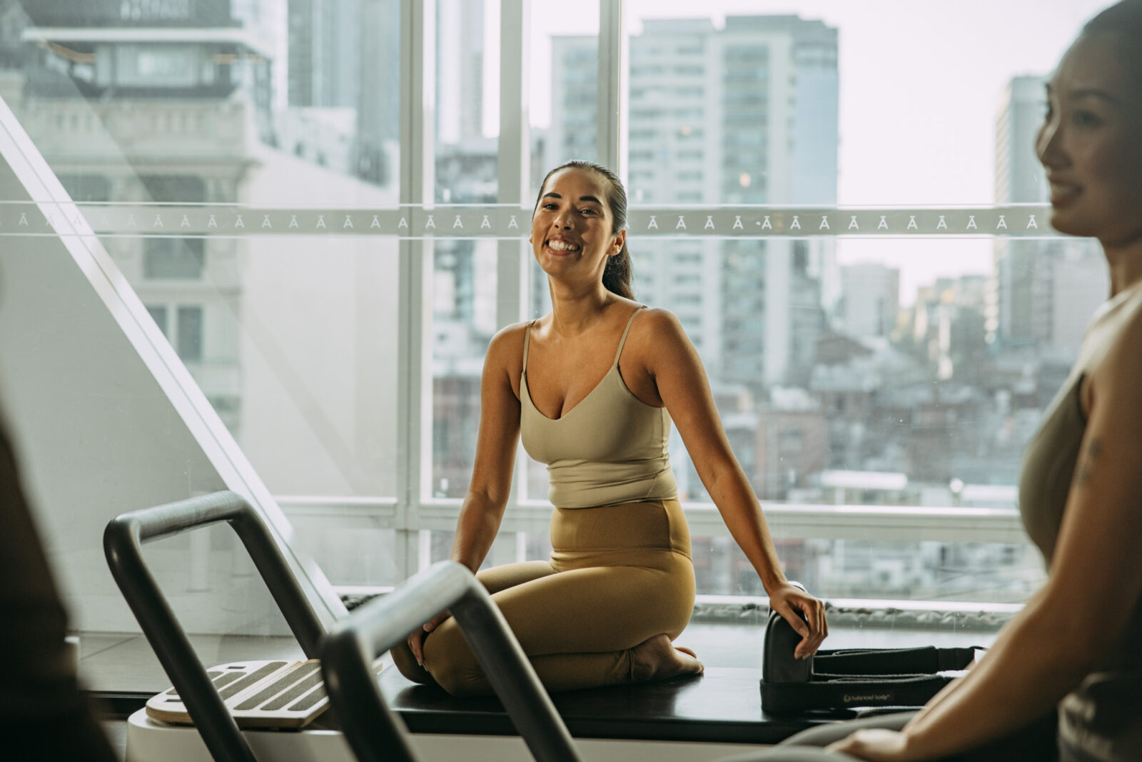 Person sitting on reformer bed