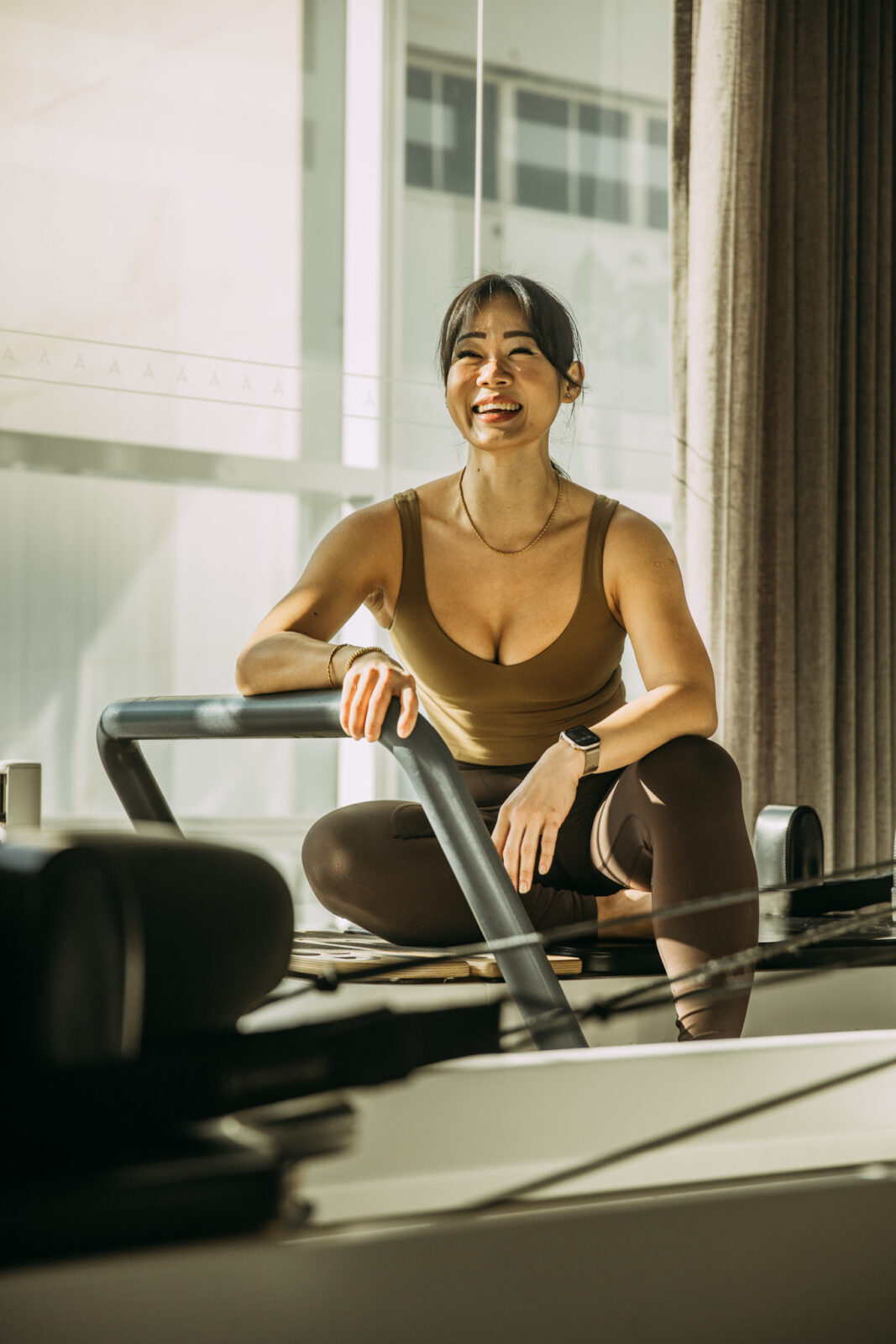 Person sitting on reformer bed