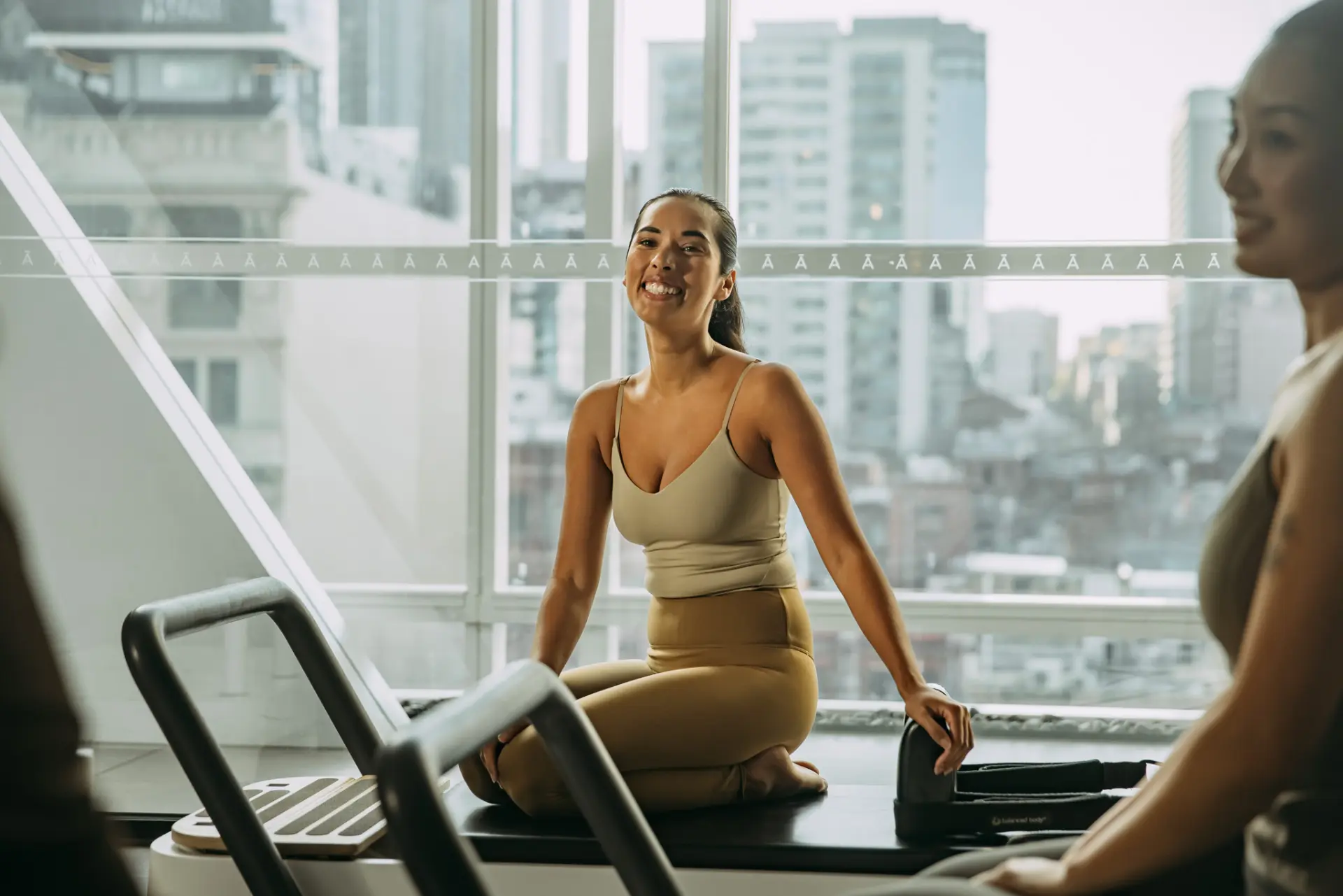 Person sitting on reformer bed