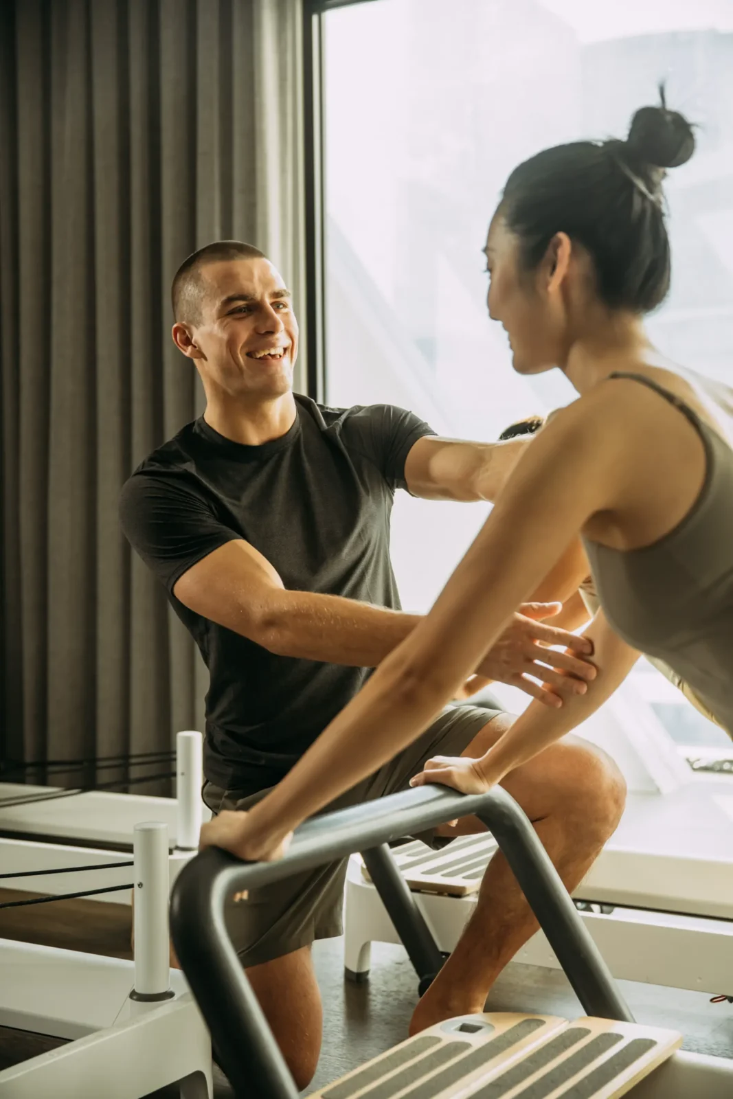 Person assisting position on reformer bed
