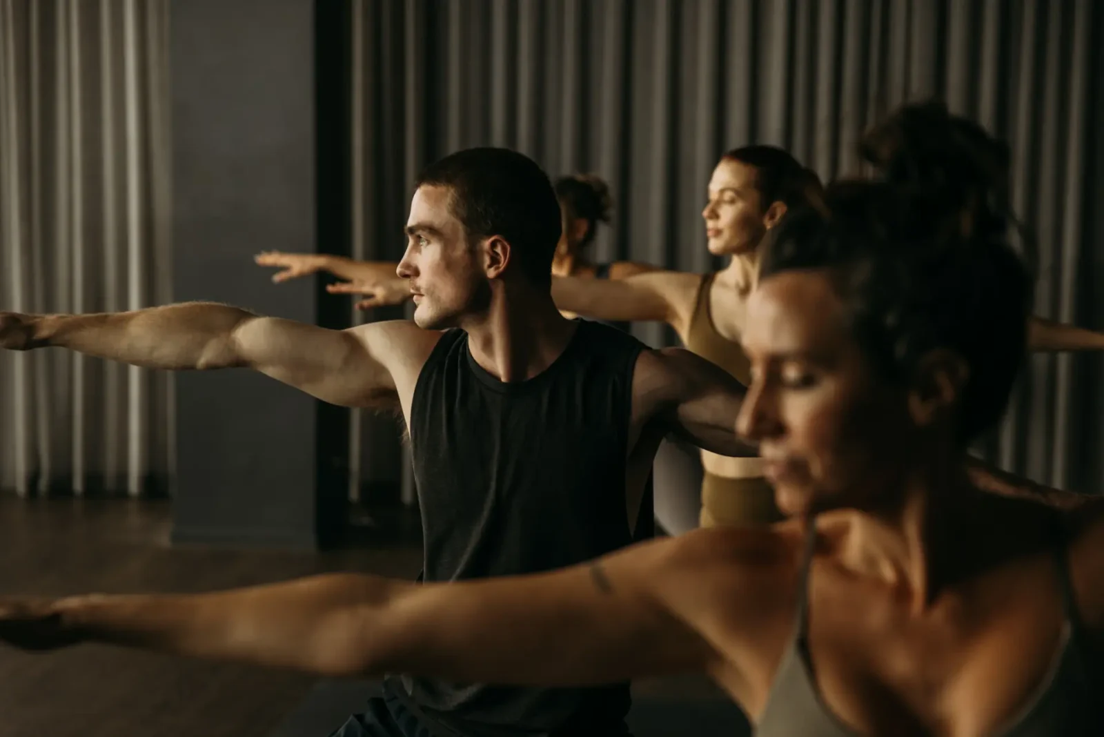 People in yoga pose with arms a part