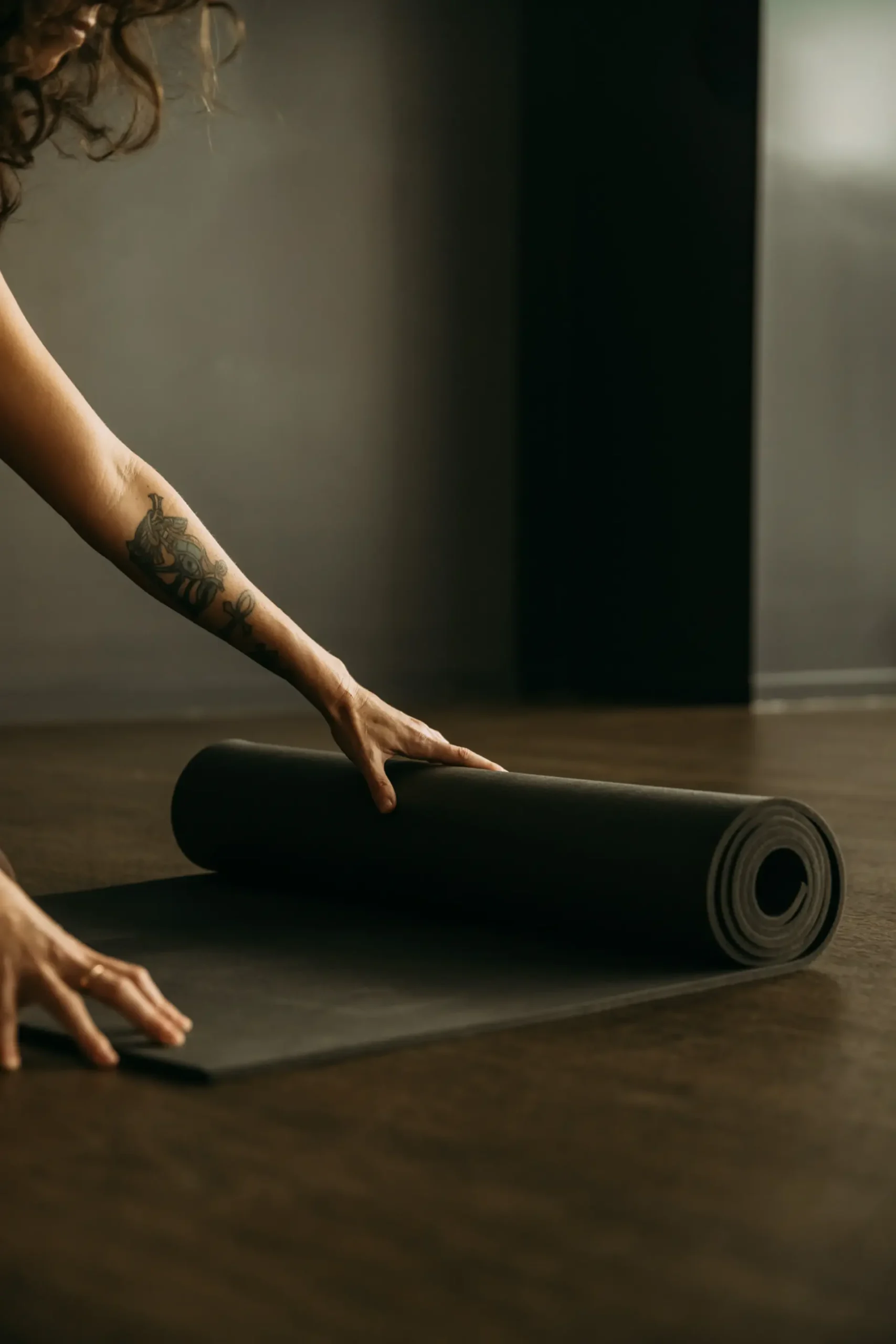 Person unrolling yoga mat