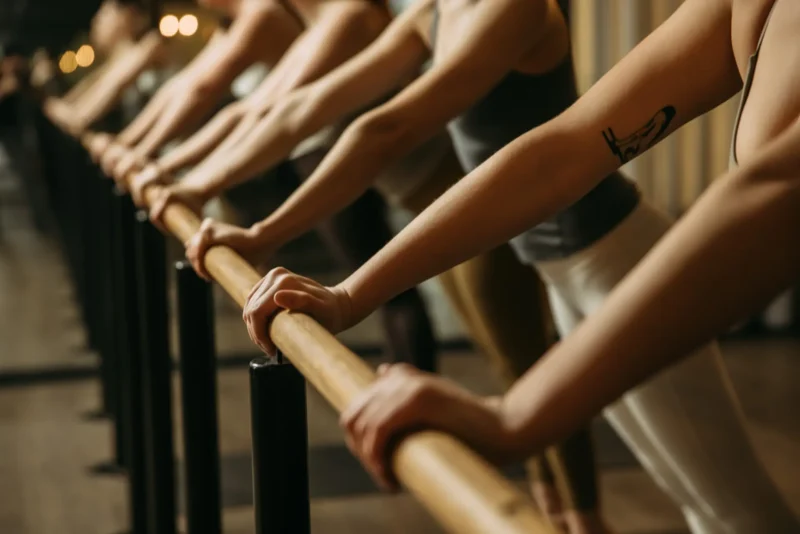 Row of people with arms on bar