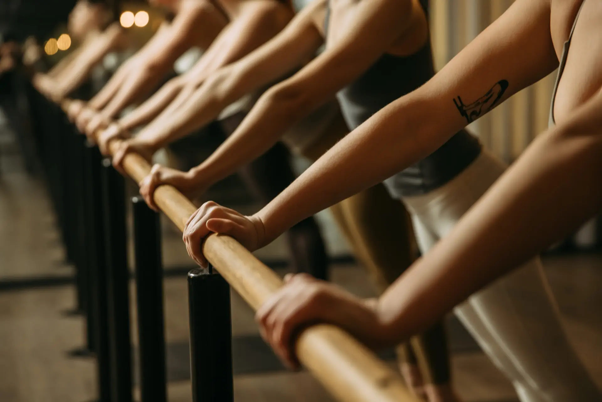 Row of people with arms on bar