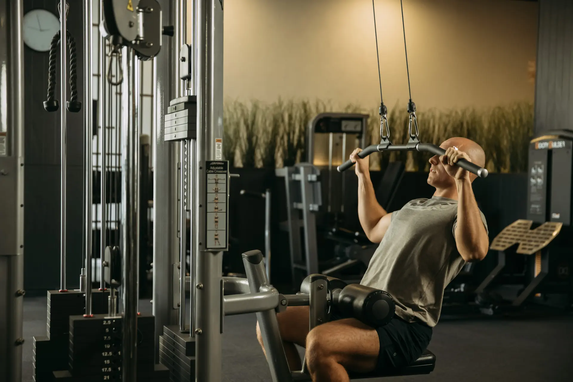 Person sitting using pulldown machine
