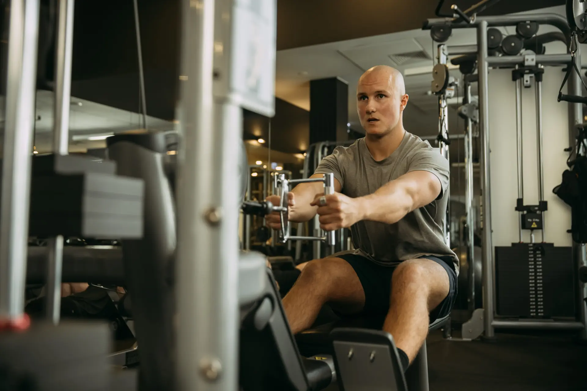 Person pulling handle from fitness machine
